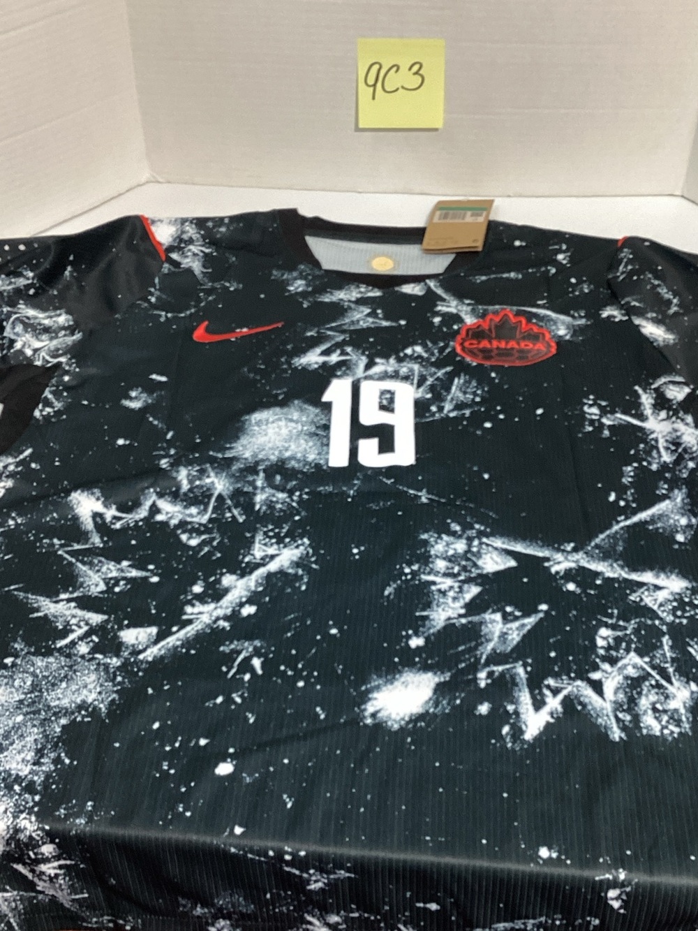 Nike Men's Black Graphic Canada Football Jersey with Red Accents
